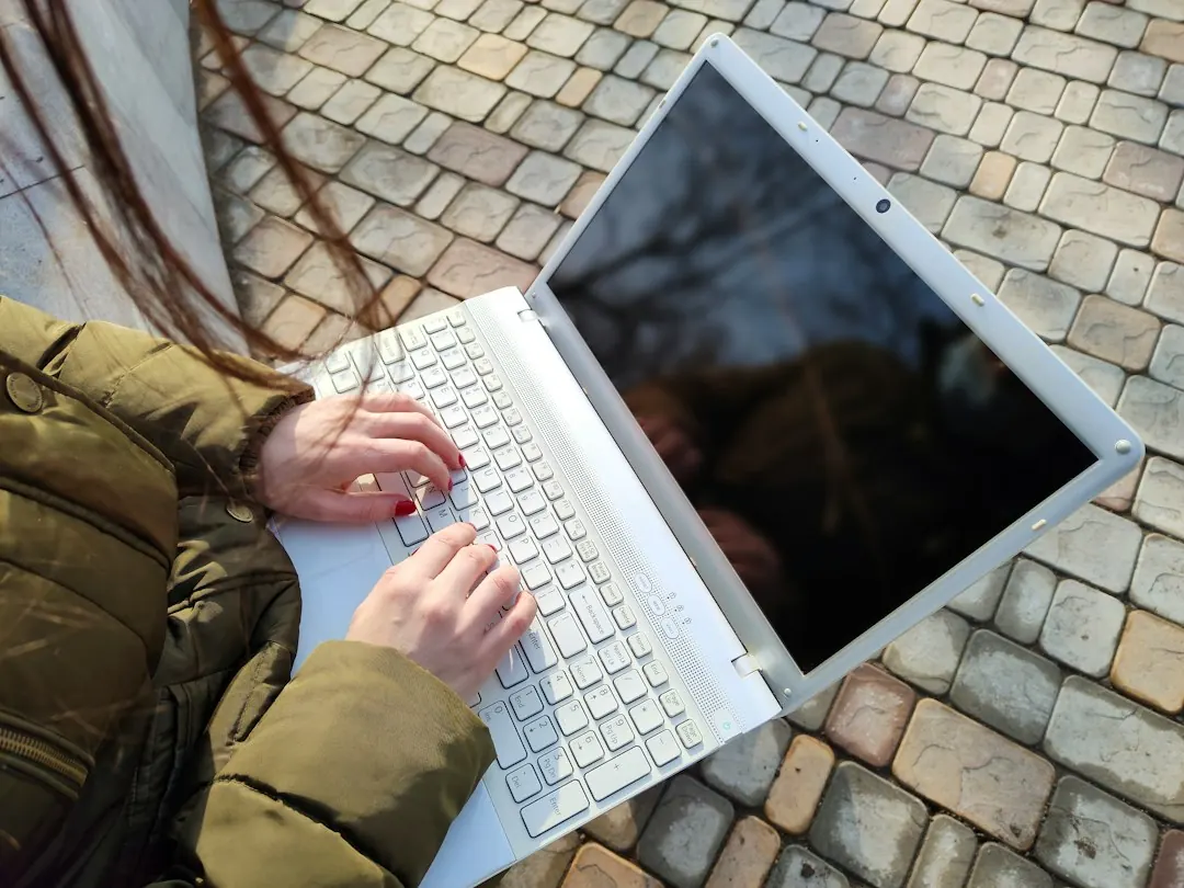 Close up of a person typing on a laptop.